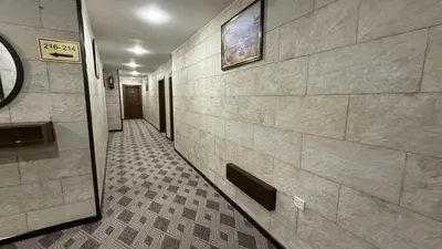 a hallway in a building with a tile floor at Rojina Hotel in Amman