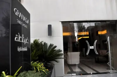 a window of a store with a sign on it at Granada Suites Hotel in Amman