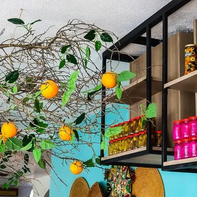 a tree branch with oranges hanging from a shelf at Crystal Suites in Amman