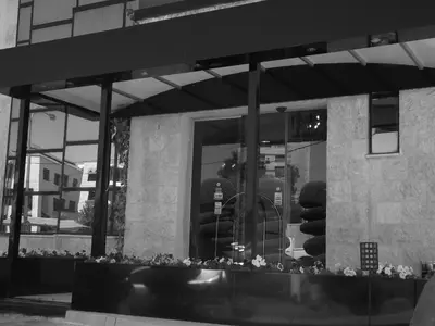 a reflection of a person in a store window at Crystal Suites in Amman