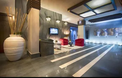 a lobby with a large vase in the middle of a room at Crystal Suites in Amman