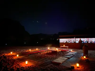 a group of candles on a beach at night at Wadi Rum Jordan Camp in Wadi Rum