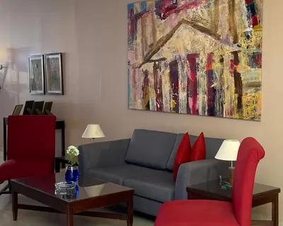 a living room with a couch and a painting at Petra Guest House Hotel in Petra