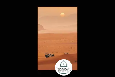 a poster of a desert with the sun in the background at Wadi Rum Moon Light Camp in Wadi Rum