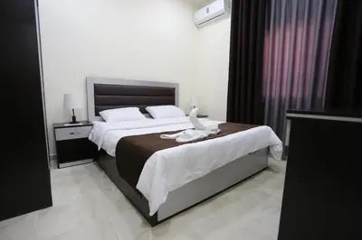 a bedroom with a bed with a bird sitting on it at 7Boys Hotel in Amman