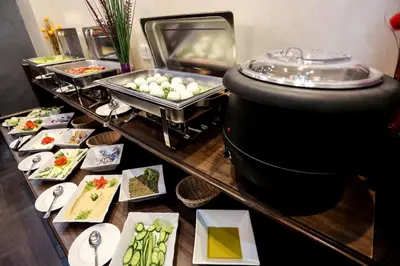 a buffet line with food on a table at 7Boys Hotel in Amman