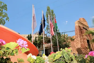 a group of flags in front of a building at Silk Road Hotel in Wadi Musa