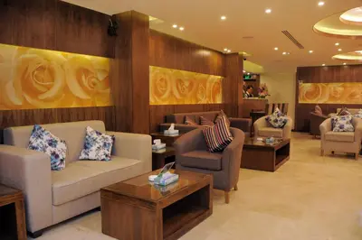 a living room with couches and chairs and tables at Al Raad Hotel in Aqaba