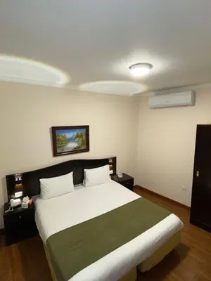 a bedroom with a large bed in a room at Rozana Hotel in Amman