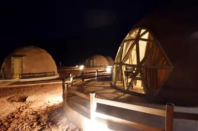 a group of domes in the desert at night at Beyond Wadi Rum Camp in Wadi Rum