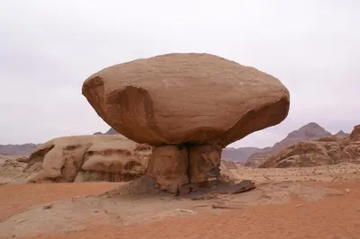 a large rock in the middle of the desert at Wadi Rum Bedouin Way Camp in Wadi Rum