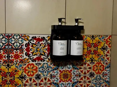 two bottles of wine sitting on top of a tiled counter at The Sydney Hotel in Amman