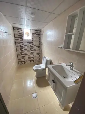 a bathroom with a white toilet and a sink at Bedouin Tours Camp in Wadi Rum