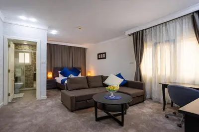 a living room with a couch and a table at Al Basem Hotel in Amman