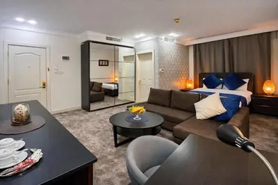 a living room with a couch and a bed at Al Basem Hotel in Amman