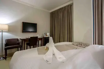 a hotel room with a bed with towels on it at Retaj Hotel in Amman