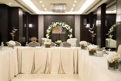 a banquet hall with white tables and chairs at Retaj Hotel in Amman