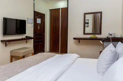 a hotel room with two beds and a television at 360 Hotel By FHM in Amman