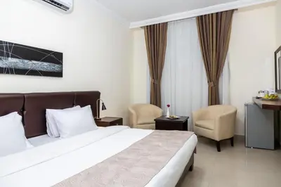 a hotel room with a bed and a chair at 360 Hotel By FHM in Amman