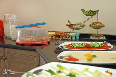 a table with plates of food on a counter at Aqaba Adventure Divers Resort & Dive Center in Aqaba