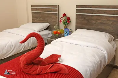 a red swan on a bed in a bedroom at Aqaba Adventure Divers Resort & Dive Center in Aqaba