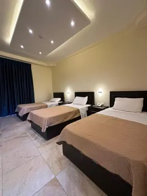 a hotel room with two beds in a room at Rumman Hotel in Madaba