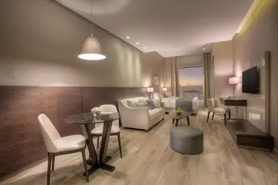 a living room with a couch and a table at The House Boutique Suites in Amman