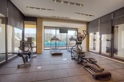 a gym with cardio equipment in a hotel room at The House Boutique Suites in Amman