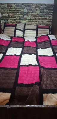 a box with two blankets on top of a bed at Petra cabin Roof top hostel in Wadi Musa
