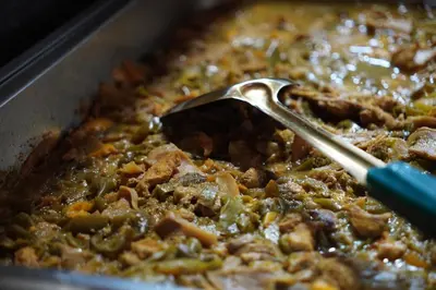 a spoon sitting in a pan of food at Petra cabin Roof top hostel in Wadi Musa