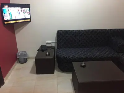 a living room with a couch and a flat screen tv at Al haramain Furnished Apartments in Amman