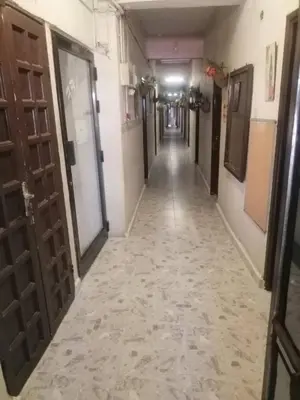 an empty hallway with doors and a hallwayngth at Cliff Hostel in Amman