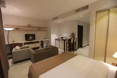a hotel room with a bed and a living room at Jabal Amman Hotel (Heritage House) in Amman