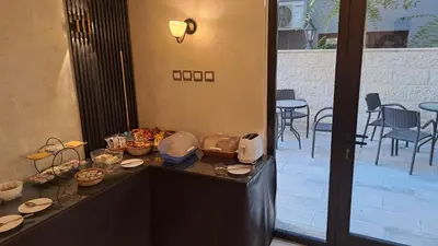 a table with plates and food on it with a patio at Jabal Amman Hotel (Heritage House) in Amman