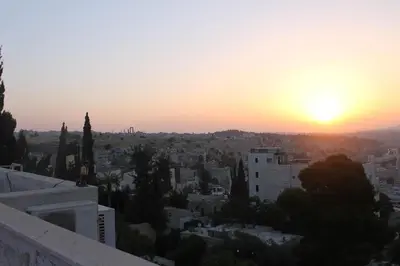 a sunset from the roof of a building at Jabal Amman Hotel (Heritage House) in Amman