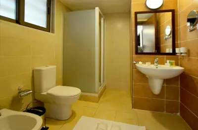 a bathroom with a toilet and a sink at Public Security Hotel & Chalets in Aqaba