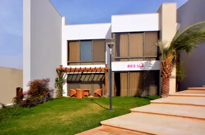 a building with some tables in front of it at Public Security Hotel & Chalets in Aqaba