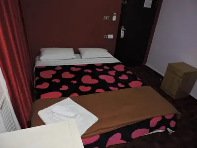 two beds in a small room with pink hearts at Valentine Inn in Wadi Musa