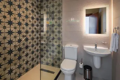 a bathroom with a toilet and a sink at Canary Boutique Hotel in Amman