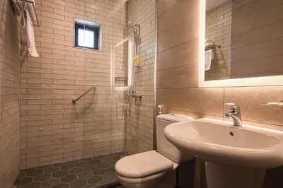 a bathroom with a toilet and a sink at Canary Boutique Hotel in Amman