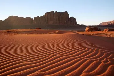 a desert with some rocks in the background at Desert Rock camp in Wadi Rum