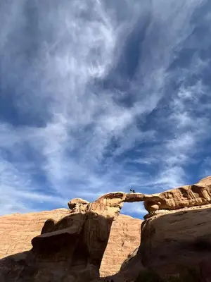 a person standing on top of a rock formation at Desert Rock camp in Wadi Rum