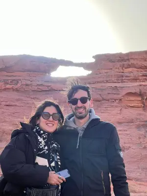 a man and a woman standing in the desert at Desert Rock camp in Wadi Rum