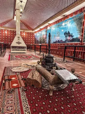a living room with a couch on a rug at Hasan Zawaideh Camp in Wadi Rum