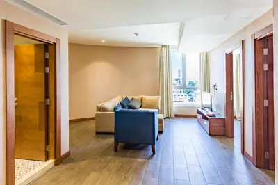 a living room with a couch and a window at The Seventh Star Hotel Suites in Amman