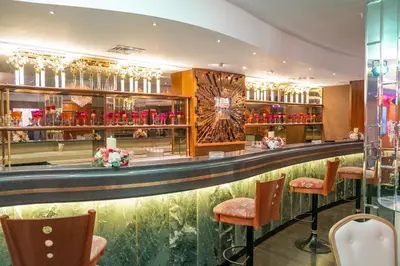 a bar at a hotel with red vases at Amman International Hotel in Amman