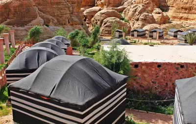 a row of domed buildings in front of a mountain at Seven Wonders Bedouin Camp in Wadi Musa