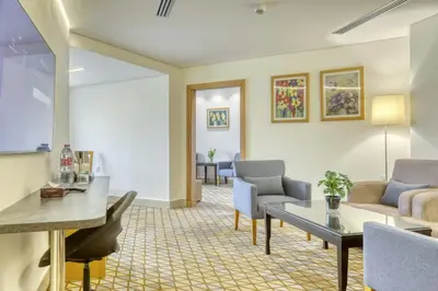 a living room with a couch and a table at Geneva Hotel in Amman