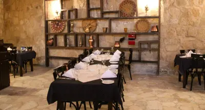 a dining room with tables and chairs in a restaurant at Hayat Zaman Hotel And Resort Petra in Wadi Musa