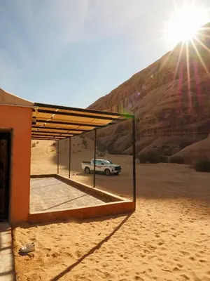 a car parked under a canopy in the desert at Wadi Rum experience in Wadi Rum